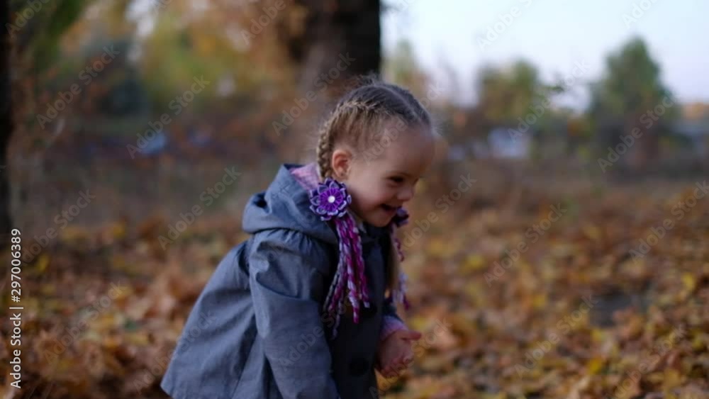 girl with down syndrome in the autumn in the park girl with down syndrome in the autumn in the park
