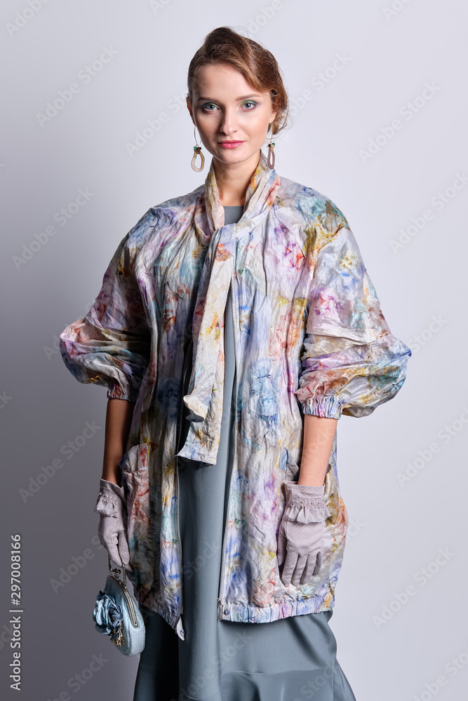 Fashion model in colorful pastel zipper coat and silk dress Fashion model in colorful pastel zipper coat and silk dress
