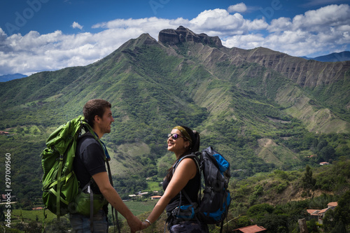 Backpacker couple holding hands surrounded by a natural landscape. Vilcabamba, Ecuador
