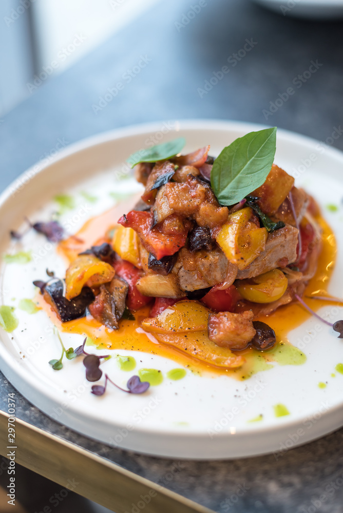 Grilled Tuna Steak with Stewed Vegetables on White Plate Grilled Tuna Steak with Stewed Vegetables on White Plate