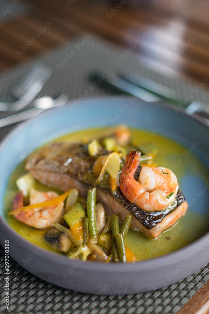 Pan Seared Salmon Steak with Prawns, Sauteed Vegetables and Spicy Citrus Sauce.