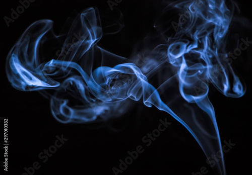 Colored blue smoke on a black background