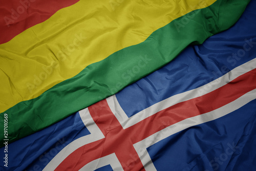 waving colorful flag of iceland and national flag of bolivia.