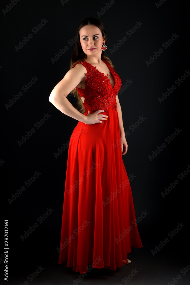 Sensual beautiful blonde woman posing in red dress.