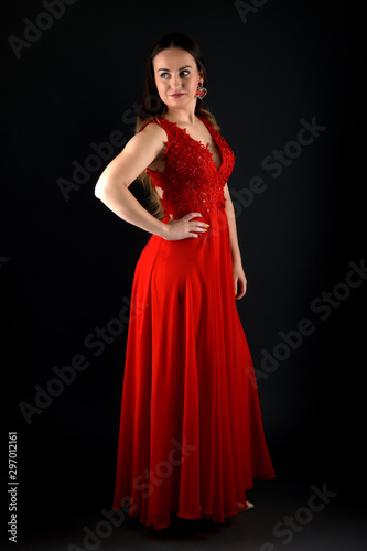 Sensual beautiful blonde woman posing in red dress.