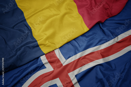 waving colorful flag of iceland and national flag of chad.