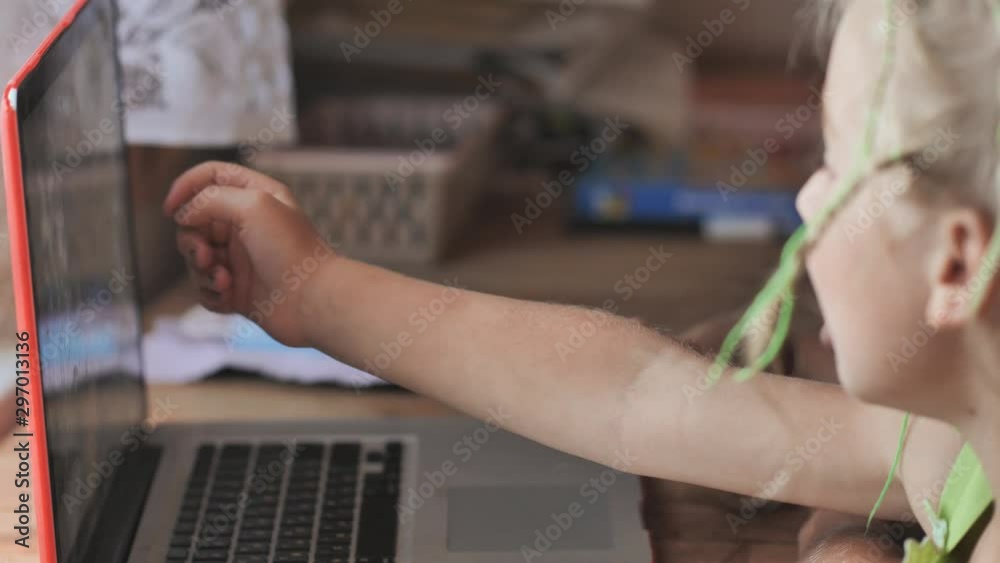Children are browsing photos on a laptop. Children are browsing photos on a laptop.