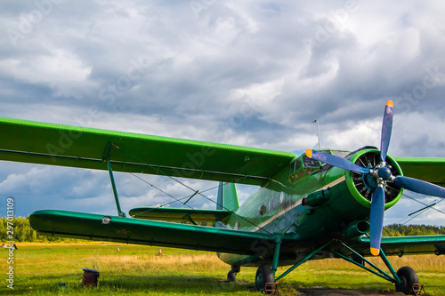 Vintage aircraft preparing for take-off on the background of a stormy sky