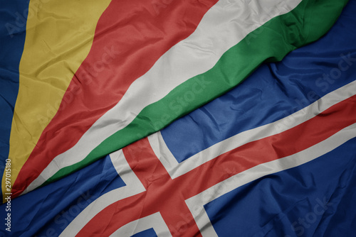waving colorful flag of iceland and national flag of seychelles.