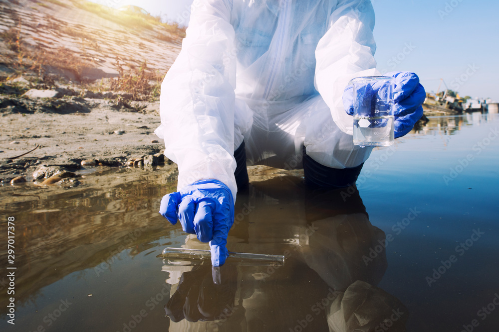 Conserve water and environment. Shot of an unrecognizable ecologist taking samples of water with test tube from city river to determine level of contamination and pollution. - obrazy, fototapety, plakaty 
