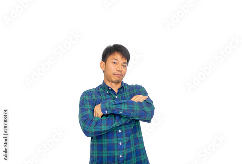 An Asian filthy man in blue plaid shirt is crossing his arms and sulking his mouth through the camera in studio.