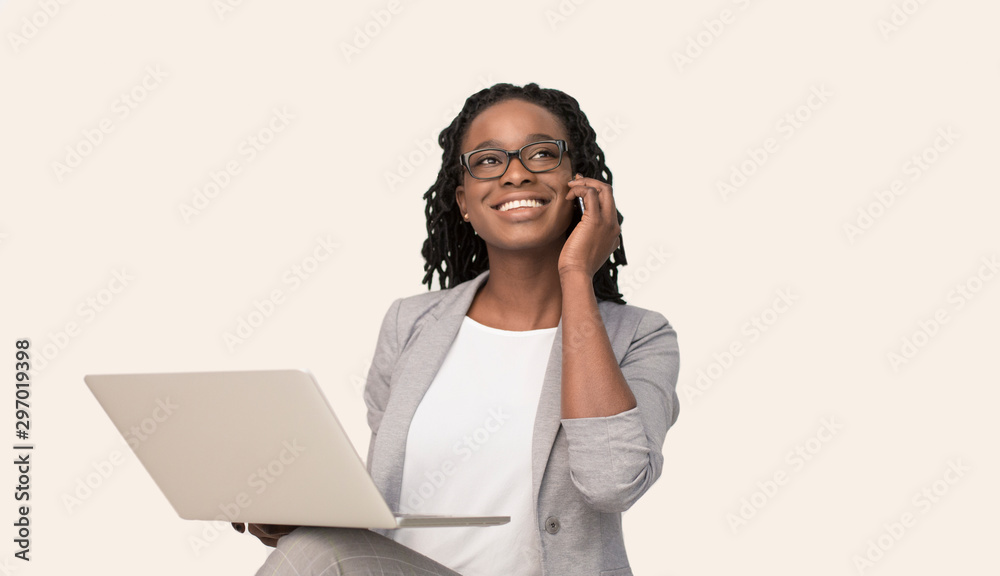 Afro Business Woman Talking On Phone Using Laptop, White Background Afro Business Woman Talking On Phone Using Laptop, White Background