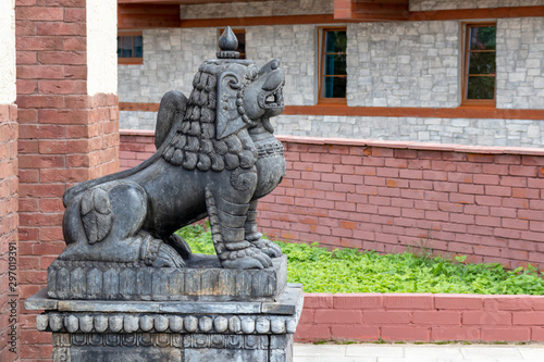 Stone traditional guard lions near the temple in the ethnic centre, copy space