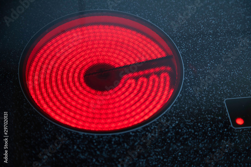 induction electric cooker with red hot plate switched on