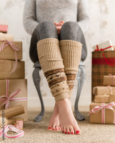 Woman legs surrounded by gift boxes. Christmas and birthday concept