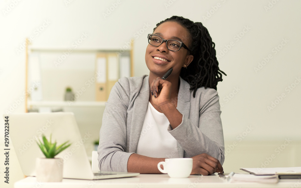 Afro Businesswoman Sitting At Laptop Imagining Something In Office Afro Businesswoman Sitting At Laptop Imagining Something In Office