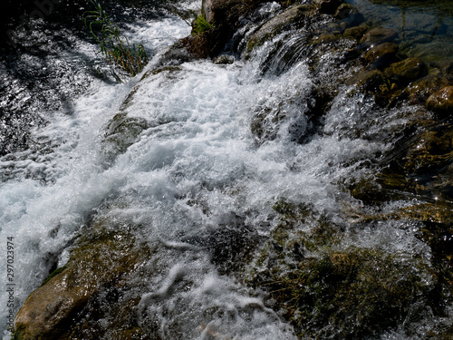 stream of water in the river with stones and foam