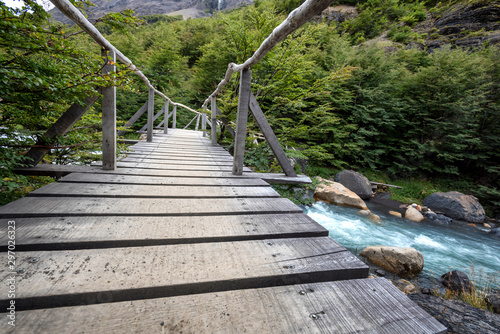 Fototapet Pedestrian bridge on trail to the base of Torres del Paine towers in Chile's mos