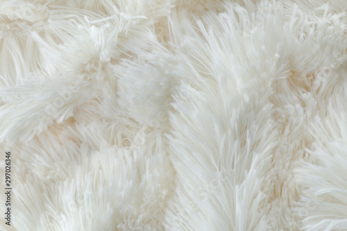 White soft wool background. Texture fluffy fur. Flat lay, top view.