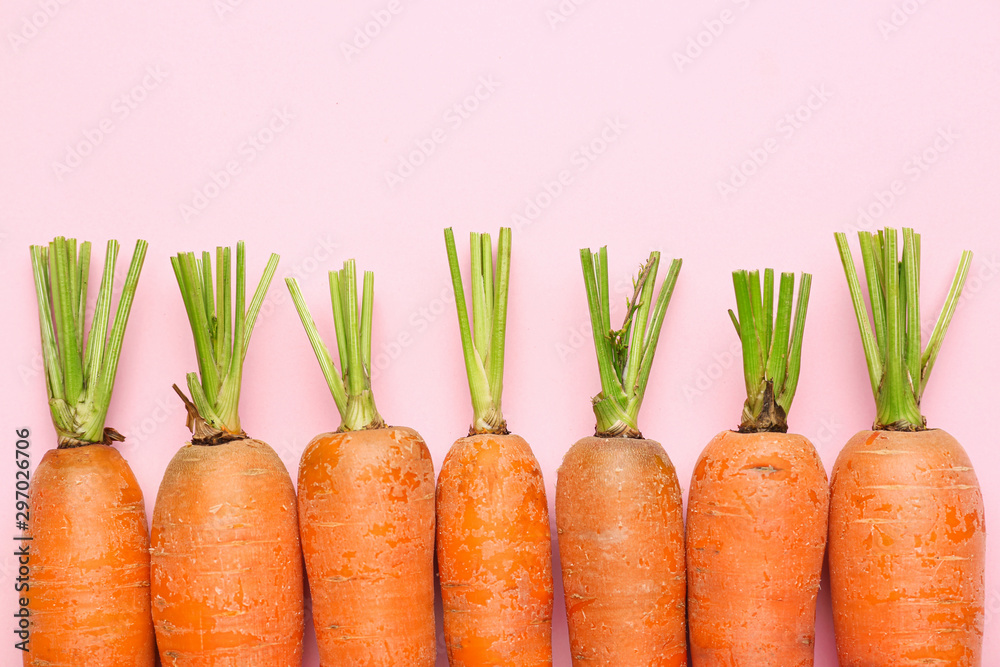 Fotografie Fresh carrots on color background
