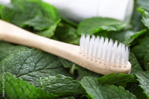 Wooden toothbrush on mint leaves