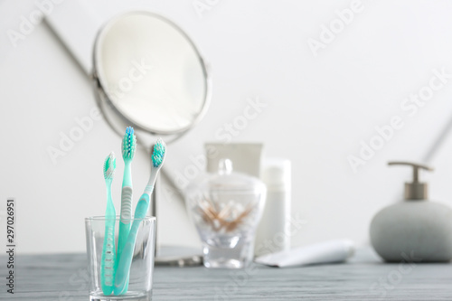 Toothbrushes on table in bathroom