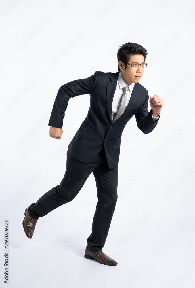 Confidential businessman in formal suit running isolated on white background in studio, determined and full power concept Confidential businessman in formal suit running isolated on white background in studio, determined and full power concept