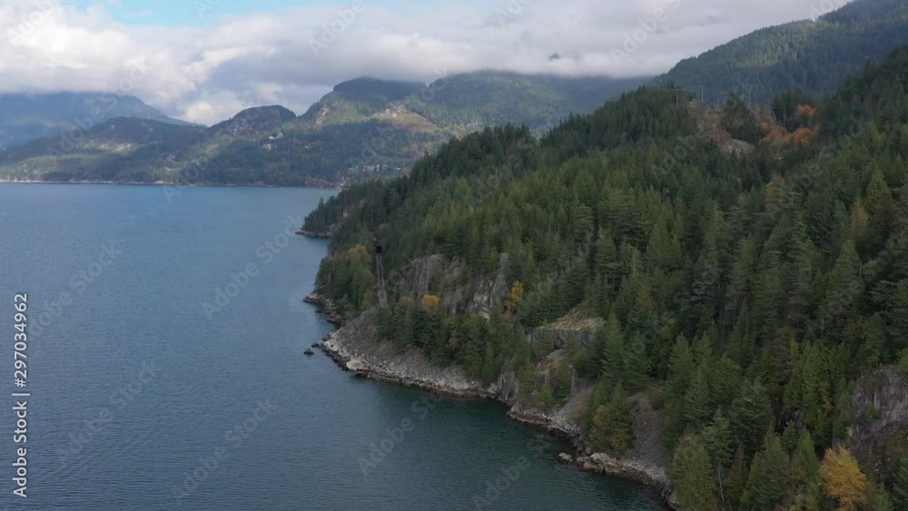 Aerial view over inlet, ocean and island with boat and mountains in beautiful British Columbia. Canada. 4K. Aerial view over inlet, ocean and island with boat and mountains in beautiful British Columbia. Canada. 4K.