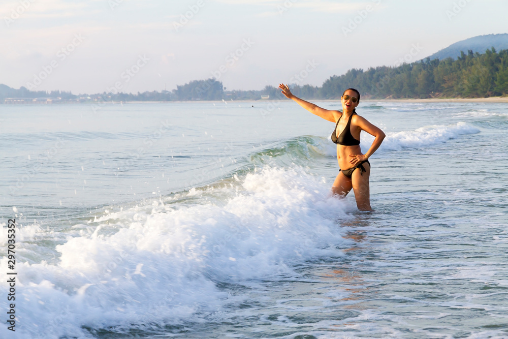 Woman with bikini pretty on wave at beach