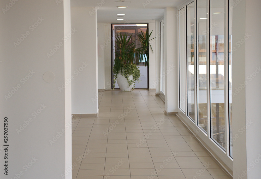 Bright white hallway with windows on the right side