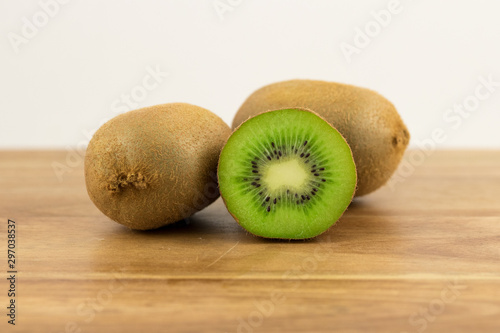 Kiwi Fruits Green Fresh And Healthy On A Wooden Timber Chopping Board Background Cut Into Segments
