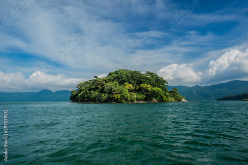 isolated green beautiful island by itself in open water