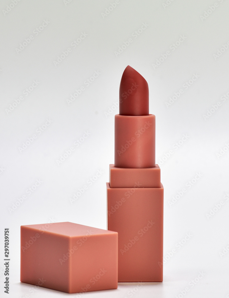 Fotografie Open the lid, put lipstick on a white background.