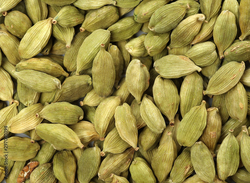 Green cardamom pods on white background