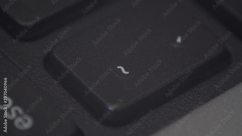 Closeup of a finger pressing a key on a computer keyboard