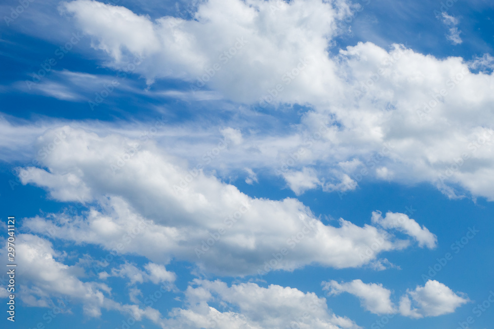 Fototapeta premium Blue sky and white fluffy clouds. Background. Wallpaper.