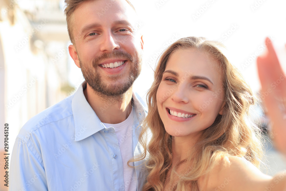 Loving cheerful happy couple taking selfie in the city Loving cheerful happy couple taking selfie in the city