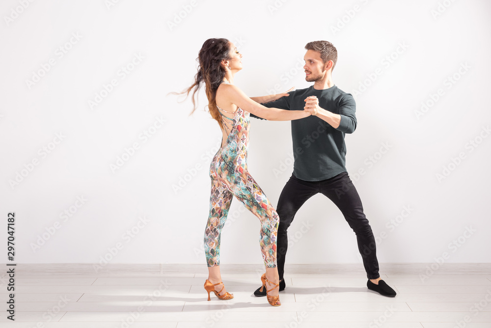 Young love couple dancing social danse kizomba or bachata over white background with copy space Young love couple dancing social danse kizomba or bachata over white background with copy space