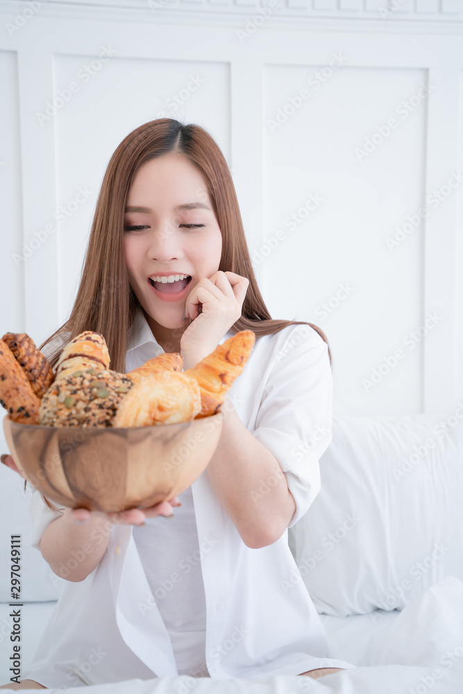 cute happiness asian female long brown hair white shite casual dress hand hold bowl of homemade bread with cheerful and laugh white wall background cute happiness asian female long brown hair white shite casual dress hand hold bowl of homemade bread with cheerful and laugh white wall background