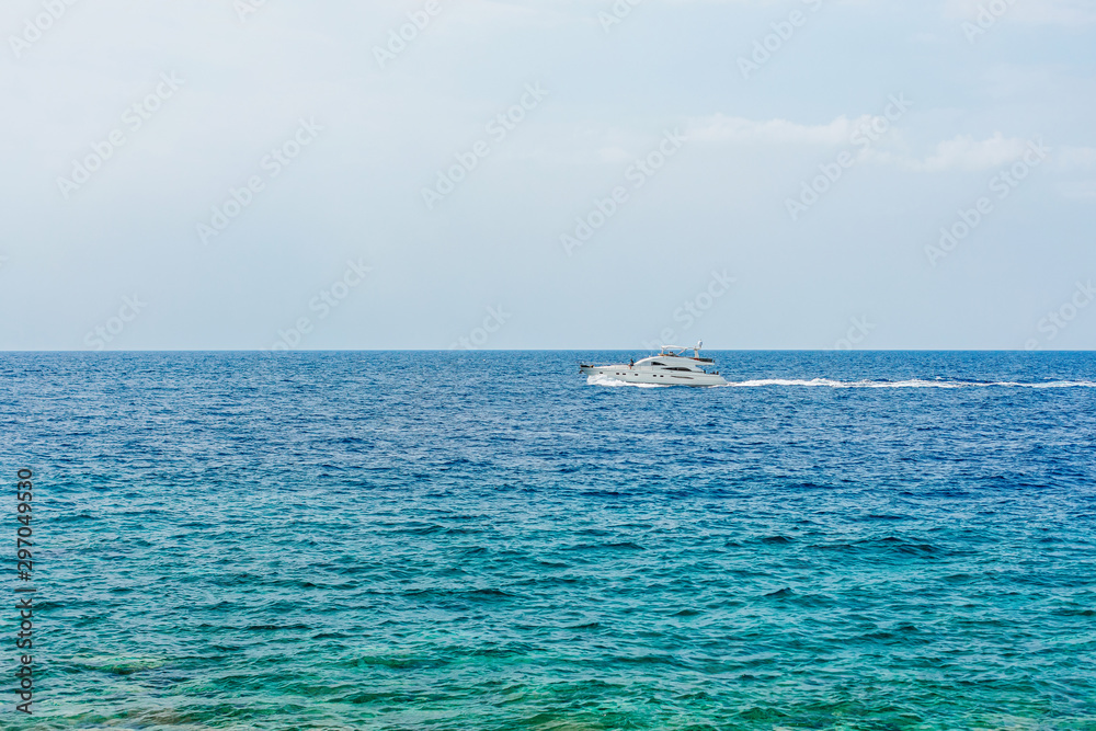 Boat with tourists on blue sea surface