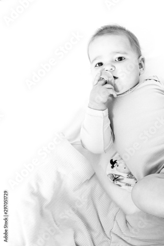 Portrait of a baby girl in her black and white bed 