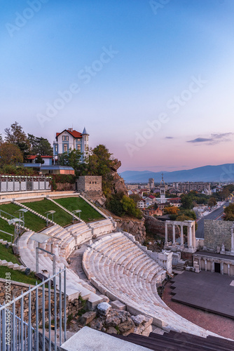 Warm autumn sunset over ancient roman amphitheatre in Plovdiv city - european capital of culture 2019, Bulgaria. The old town is included in UNESCO World Herritage