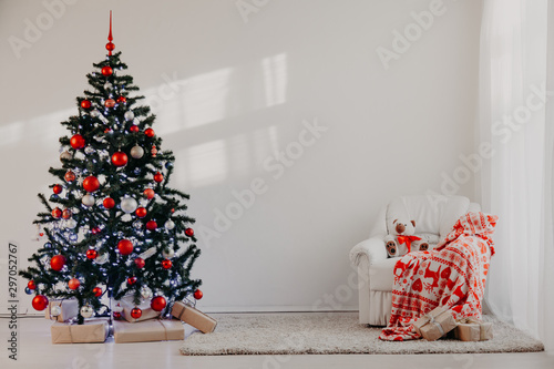 Christmas tree in a white room for Christmas with gifts photo