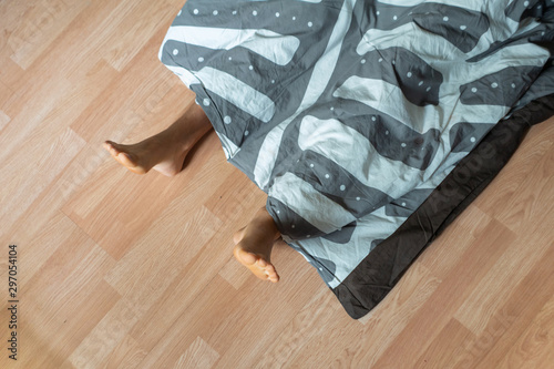 top view of young male sleeping on the floor, healthy concept, straight position on wooden floor photo