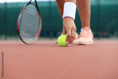 Tennis racket and the ball on tennis court. © ty