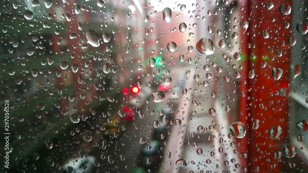  Rolling in outdoors seen through window pane with raindrops 