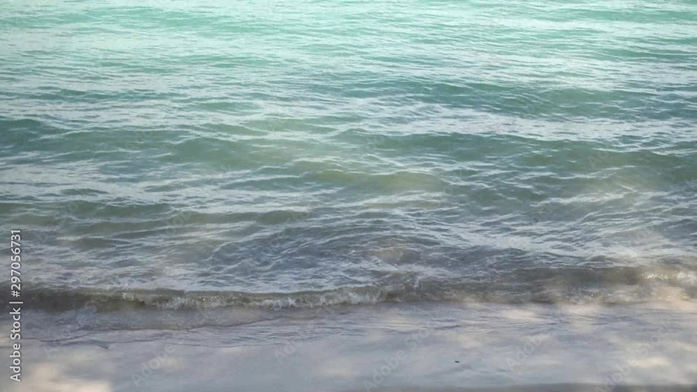 The sea with waves hit the sandy beach in the morning, with copy space writing The sea with waves hit the sandy beach in the morning, with copy space writing