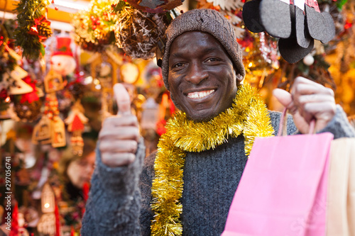 Laughing guy after shopping on Christmas market