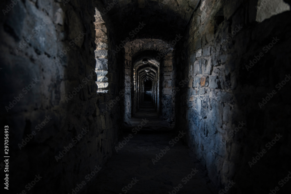 darkness underground passage in cold medieval castle dungeon 