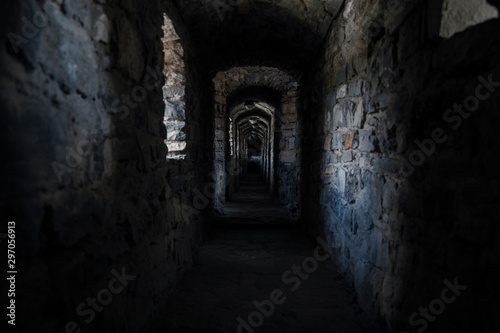 darkness underground passage in cold medieval castle dungeon 